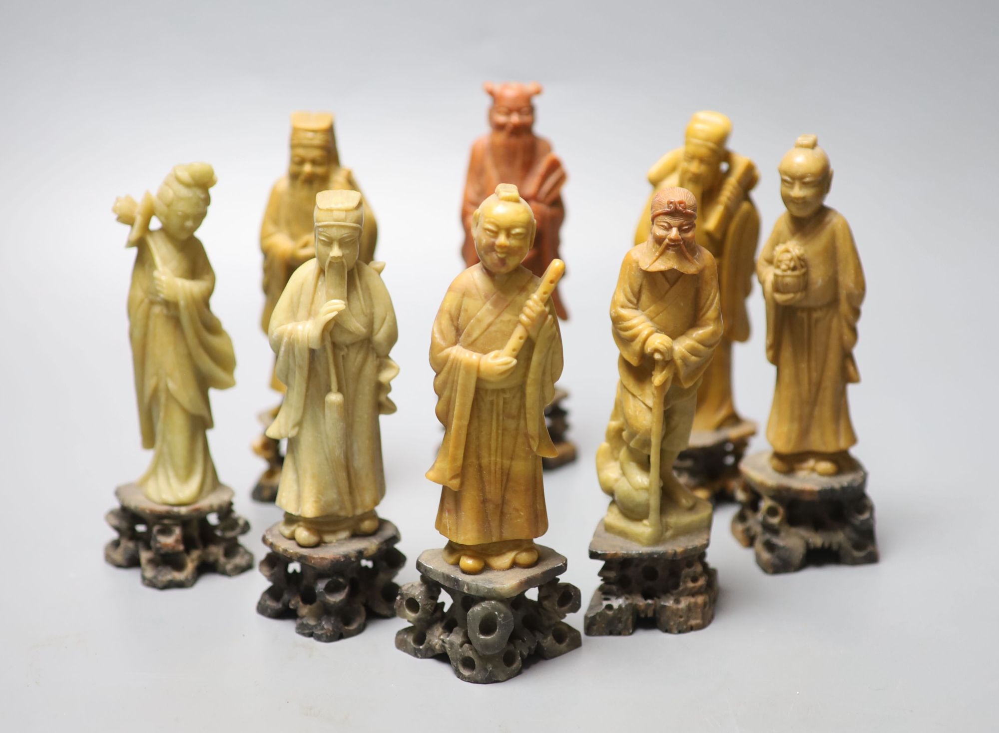 A set of soapstone carvings of the Eight Immortals, early 20th century, in varied colour of stone, height 16cm